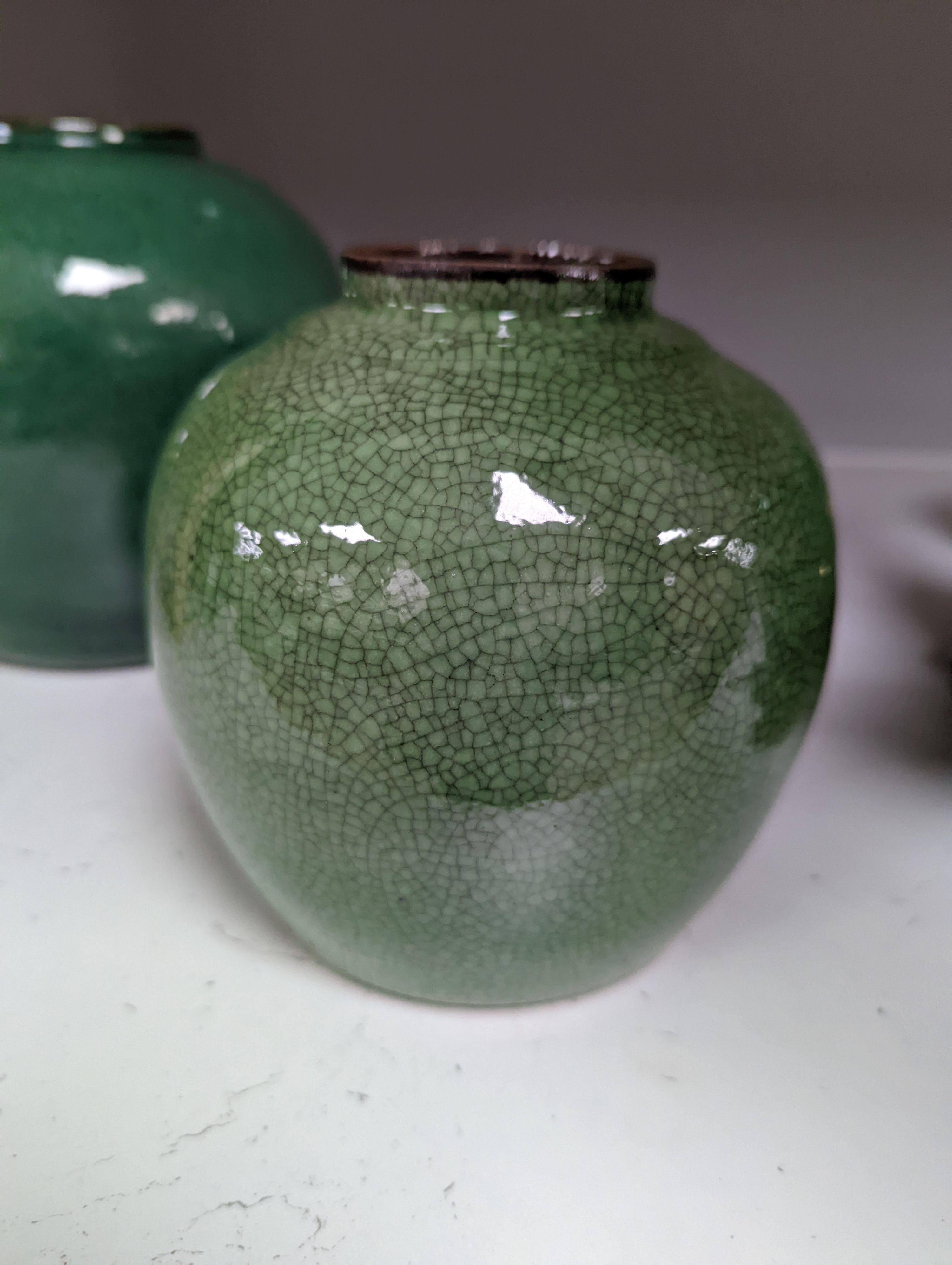 A 19th century Chinese green glazed model of a lion-dog, and two green crackle glaze jars, tallest 16cm